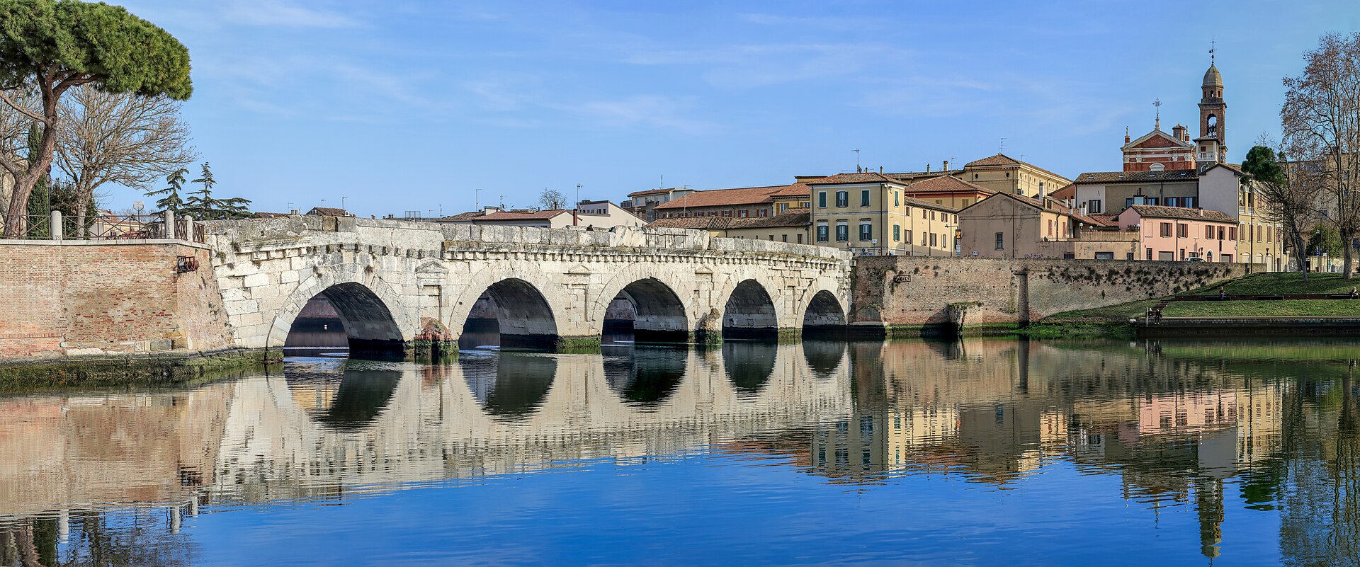 The Tiberius Bridge and Rimini historic centre — the Roman bridge has stood since 21 AD, around 10–15 km from Rimini Verucchio Golf Club.