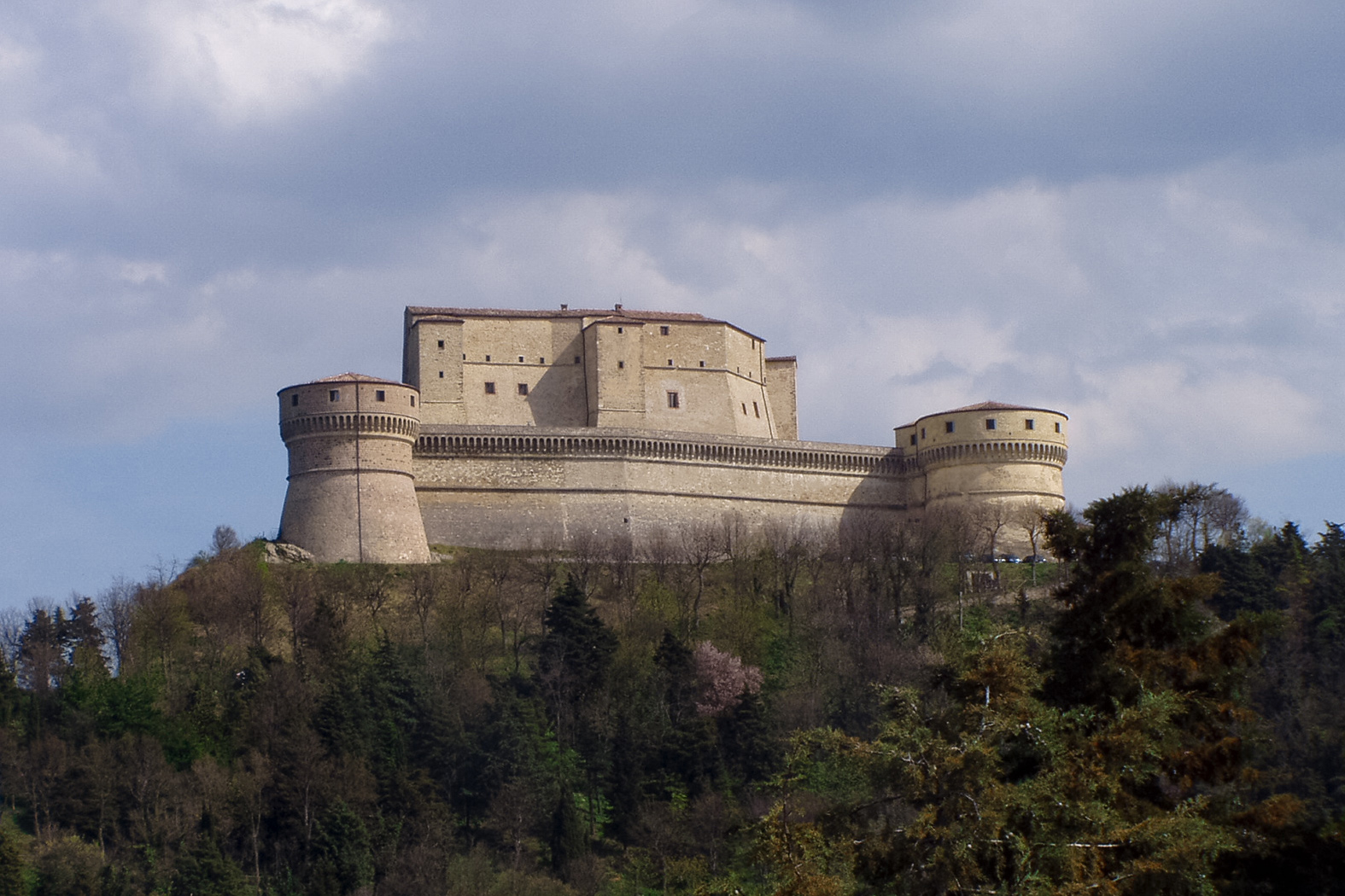 The Rocca di San Leo — a Renaissance fortress perched on a vertical cliff in Emilia-Romagna, part of the skyline seen from Rimini Verucchio Golf Club.